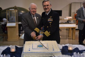 NHF Chairmain Admiral Bruce DeMars, USN (Ret.) and Captain David Ogburn, USN cut the cake.