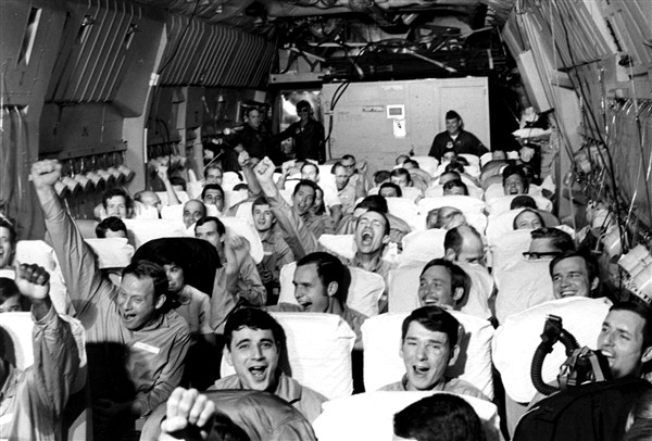 Newly freed prisoners of war celebrate as their C-141A aircraft lifts off from Hanoi, North Vietnam, on Feb. 12, 1973, during Operation Homecoming. (Defense.gov)