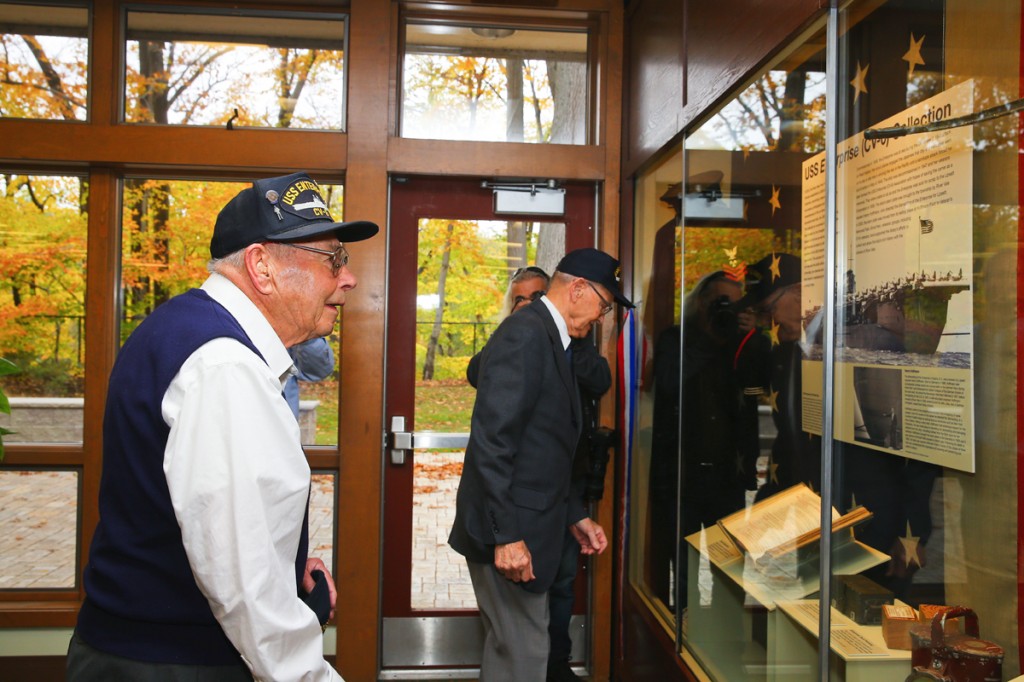 CV-6 Veterans Richard Dunbar (L) and Bill Norberg (R) viewing the Enterprise Collection
