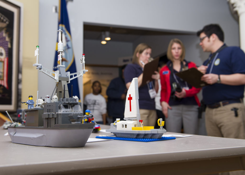 NORFOLK (Feb. 8, 2014) Judges examine an entry during the Brick-by-Brick Lego Shipbuilding Competition at the Hampton Roads Naval Museum. Participants in the annual competition used Lego building blocks to create ships while learning basic concepts of science, technology, engineering and mathematics. (U.S. Navy photo by Mass Communication Specialist Seaman Adam Austin/Released) 