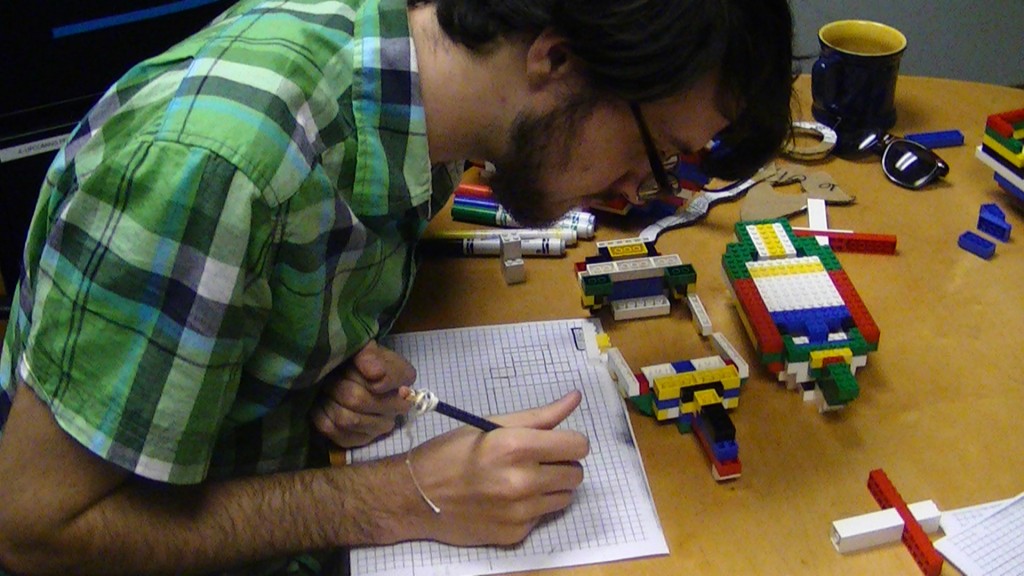 Summer Intern Samuel Nelson graphs out the beginnings of a LEGO Ship, Summer 2011. (Photo by Matthew Eng/HRNM)