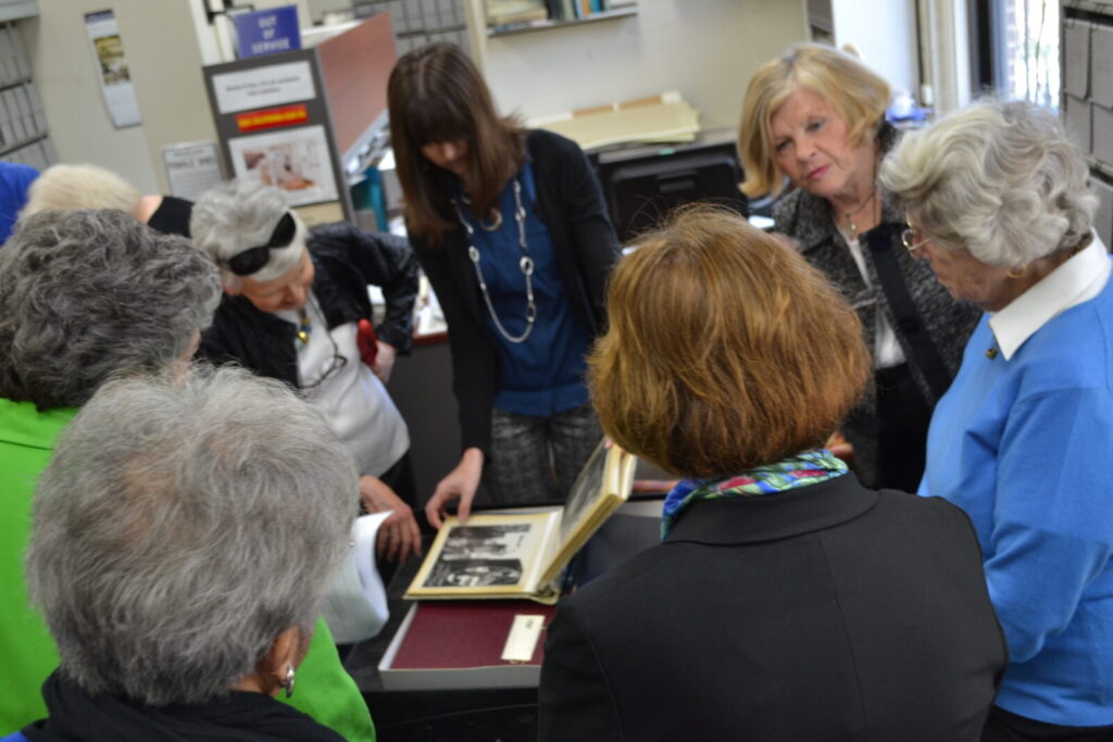 Lead archivist Lisa Crunk shows some of the sponsors materials within their collection.