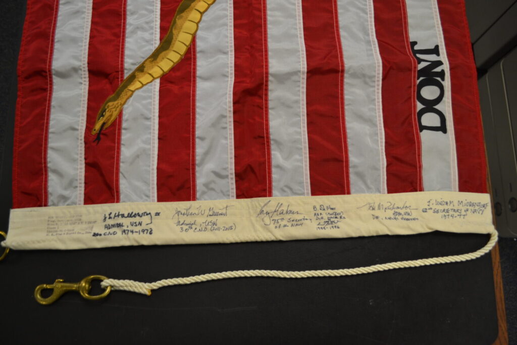 1975 Navy Jack signed by Holloway, Greenert, Mabus, Richardson, DeMars, and Middendorf (Photo by NHF/Matthew Eng/Released)