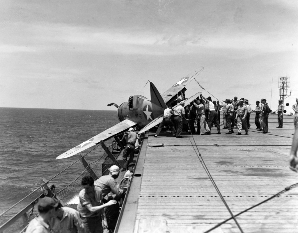 Photo #: 80-G-12906 Brewster F2A-3 Buffalo fighter, of Marine Fighting Squadron 211 (VMF-211) Rests in the flight deck gallery netting after suffering landing gear failure while landing on board USS <em><p id=
