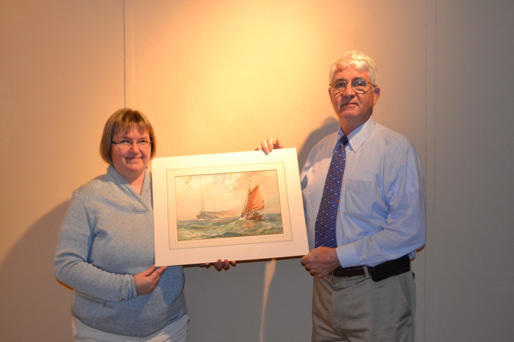 NHF Executive Director Captain Todd Creekman, USN (Ret.) poses with the Gribble watercolor with NHHC Navy Art Curator Pam Overmann (NHF Photo/Matthew Eng)
