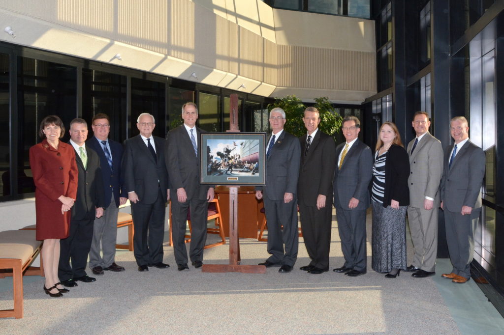 Executive Director Captain Todd Creekman, USN (Ret.) stands with the Thomas Hart Benton print “Cut the Line” alongside members of the Cincinnati Insurance Company during a visit to their headquarters during his January 2016 visit. (left to right): Dawn Alcorn, Vice President, Administrative Services; Mike Weigel, Press Operator II, Printing; Roger Chamberlain, Secretary and Manager, Printing; Jack Schiff, Jr., Chairman of the Executive Committee, Cincinnati Financial Corporation; Steve Johnston, President and CEO, Cincinnati Financial Corporation; Captain Todd Creekman, USN (Ret), Executive Director, Naval Historical Foundation; Dirk Debbink, Director, Cincinnati Financial Corporation; Tim Timmel, Senior Vice President, Operations; Lori Justice, Graphic Designer II, Printing; Brian Wood, Vice President, Human Resources; and Jim Streicher, Vice President, Personal Lines Support.