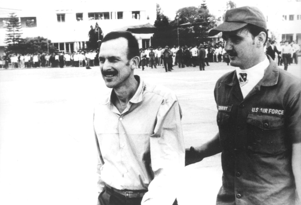 Commander Coskey escorted to airplane at Hanoi's Gia Lam Airport, 1973.