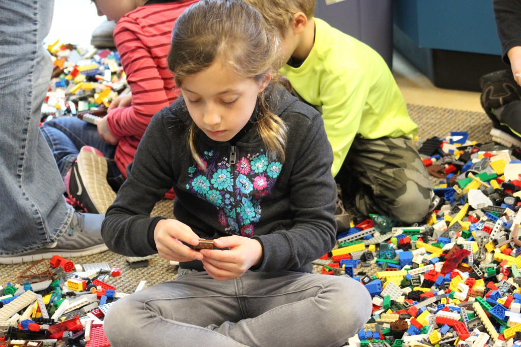 A visitor to last week's LEGO Shipbuilding event at the Kalmar Nyckel Foundation builds a ship in the "free play" area (NHF Photo/Matthew Eng/Released)