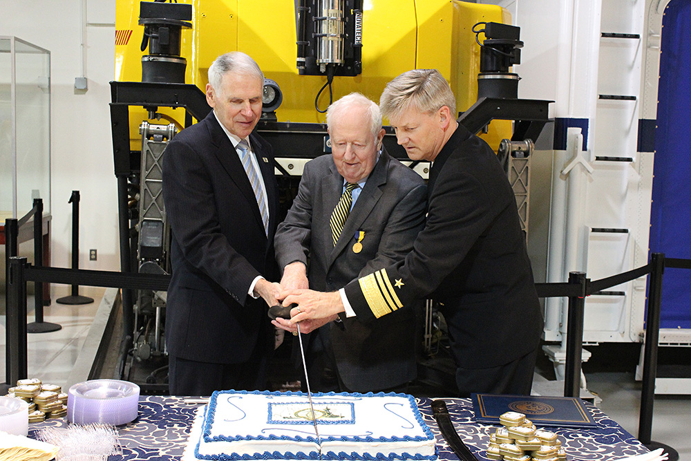 NHF Chairman Adm. William J. Fallon, USN (Ret.), NHF Chairman Emeritus Adm. Bruce DeMars, USN (Ret.), and Director of the Navy Staff, Vice Admiral Robert Thomas, USN cut the NHF birthday cake. 