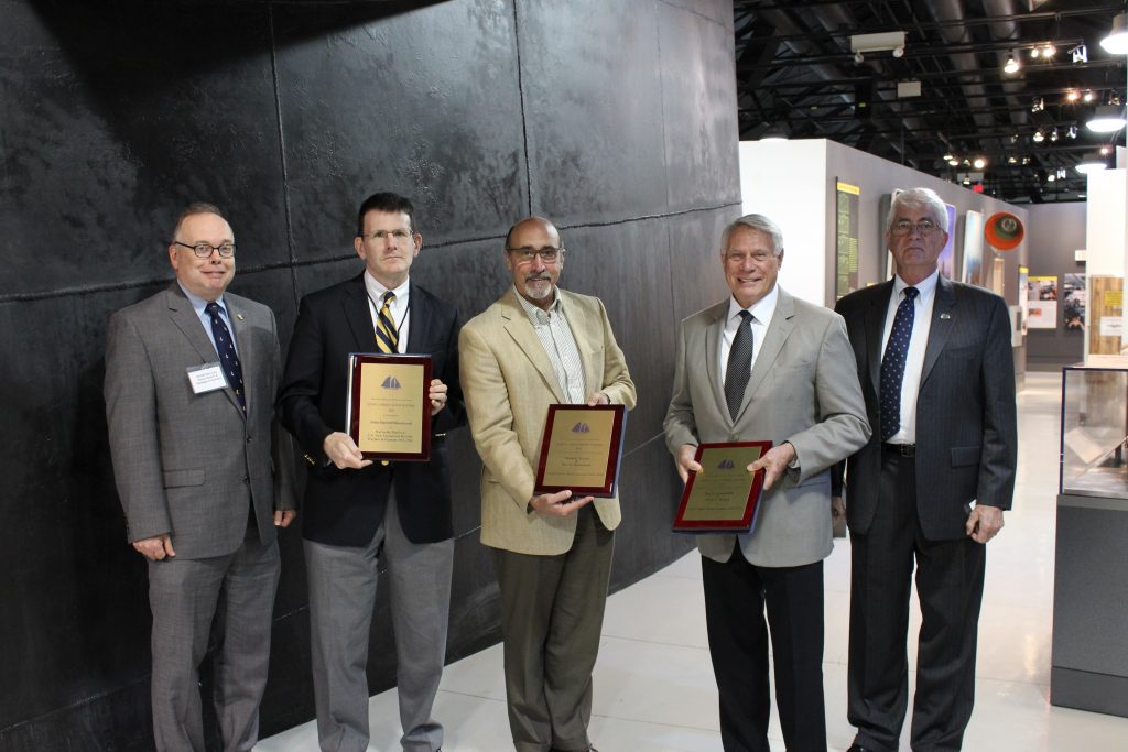 NHHC Director Admiral Sam Cox, USN (Ret.) and NHF Director Captain Todd Creekman, USN (Ret.) stand next to Naval History and Heritage Command historians who recently received the John Lyman book prize for their contributions to naval history from the North American Society for Oceanic History during a special presentations at the 2016 NHF Annual Meeting.
