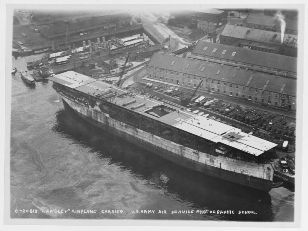 Under reconstruction from the collier JUPITER at Norfolk Navy Yard, Portsmouth, Virginia, circa late 1921. (NHHC Photo # NH 93538)